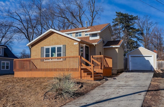 view of front of house with a garage and an outdoor structure