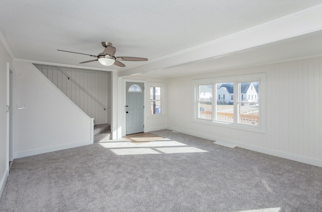 unfurnished living room with light carpet, ornamental molding, and ceiling fan