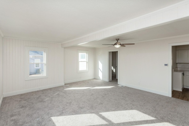 empty room featuring crown molding and light carpet