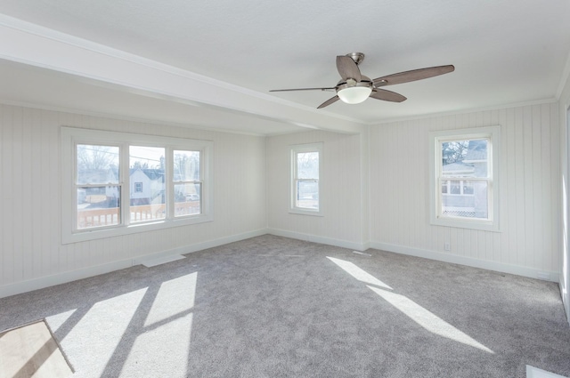 empty room with crown molding, light carpet, and ceiling fan