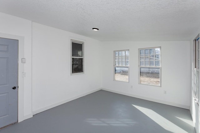 empty room featuring concrete flooring and a textured ceiling