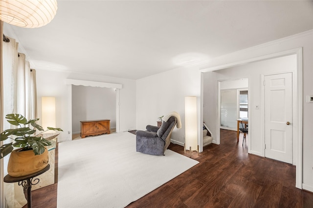 sitting room featuring ornamental molding and dark hardwood / wood-style flooring