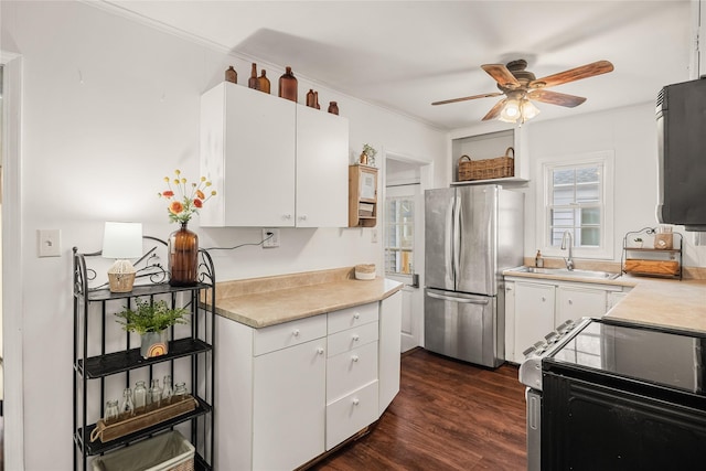 kitchen featuring white cabinetry, sink, stainless steel fridge, dark hardwood / wood-style flooring, and electric stove