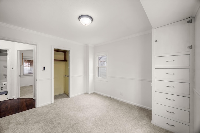 unfurnished bedroom featuring ornamental molding, light carpet, and a closet