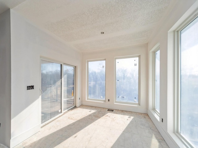 sunroom / solarium featuring a healthy amount of sunlight