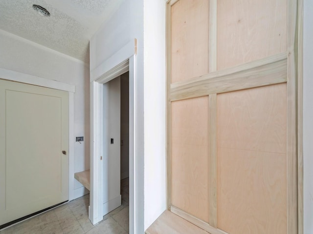 hall with a textured ceiling