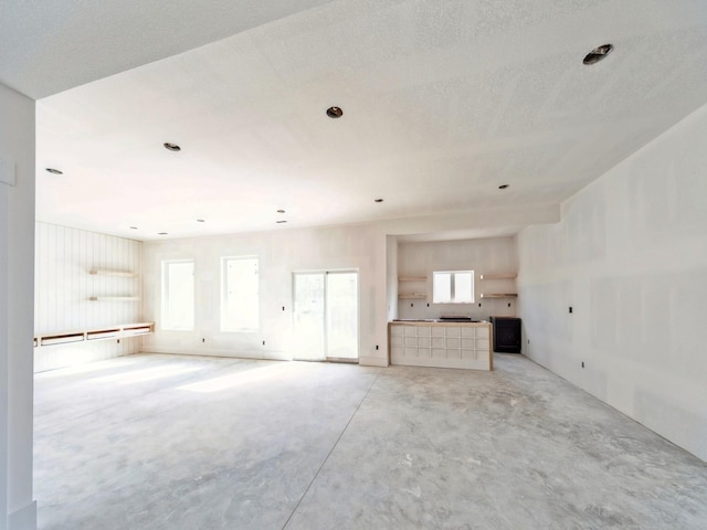 unfurnished living room with plenty of natural light