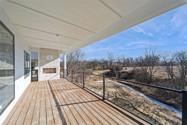 deck featuring an outdoor stone fireplace