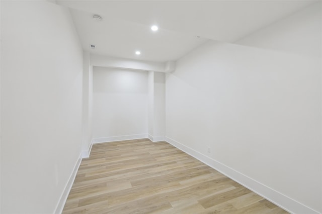 finished basement featuring baseboards, recessed lighting, and light wood-style floors