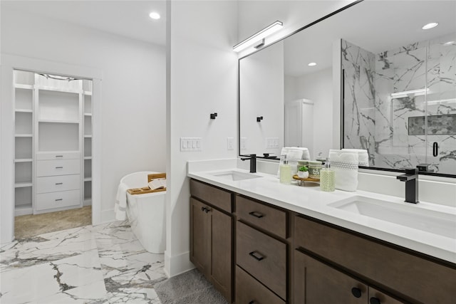 bathroom featuring recessed lighting, a marble finish shower, and a sink