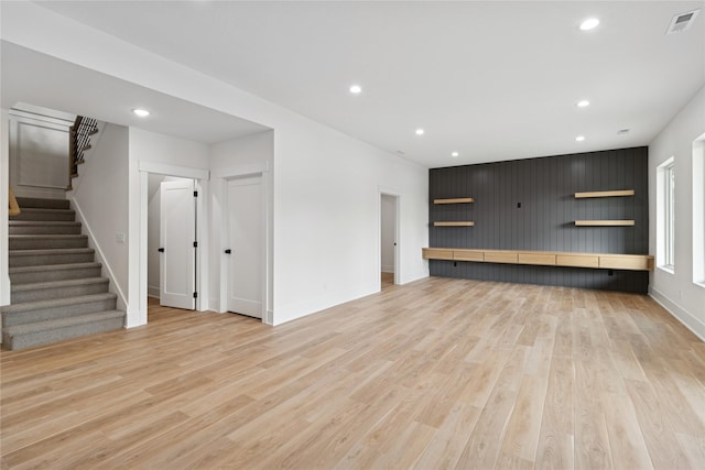 unfurnished living room featuring recessed lighting, stairway, visible vents, light wood-style flooring, and baseboards