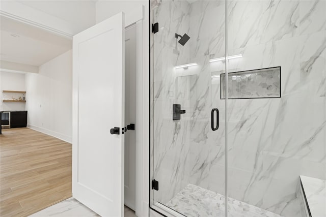 full bathroom with baseboards and a marble finish shower