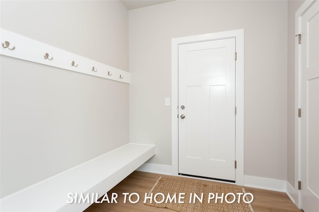 mudroom featuring wood finished floors and baseboards