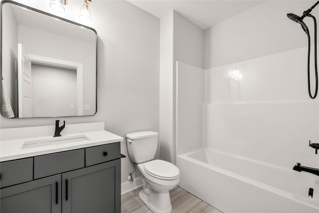 full bathroom featuring toilet, vanity, and  shower combination