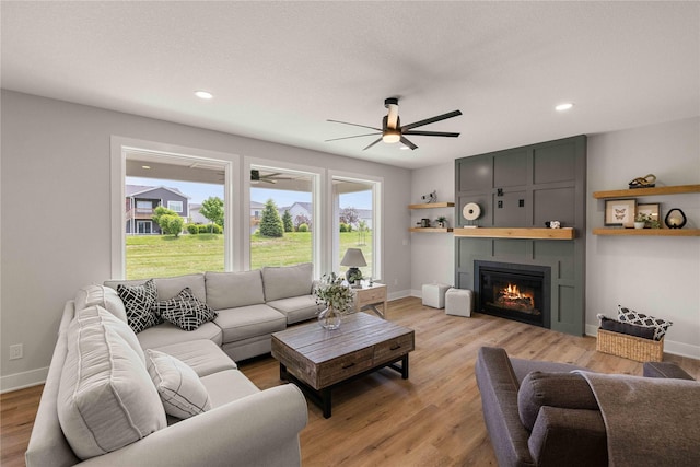 1252 S Radley St, West Des Moines, IA 50266 - living area featuring ceiling fan, light wood-style flooring, a large fireplace, baseboards, and recessed lighting