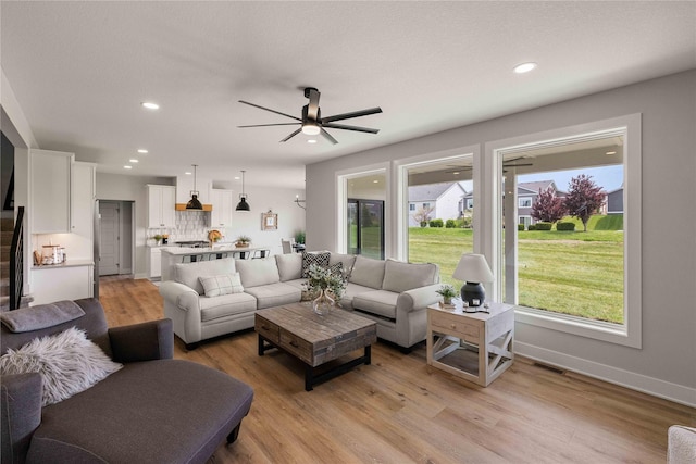1252 S Radley St, West Des Moines, IA 50266 - living room featuring light wood finished floors, a ceiling fan, recessed lighting, and baseboards