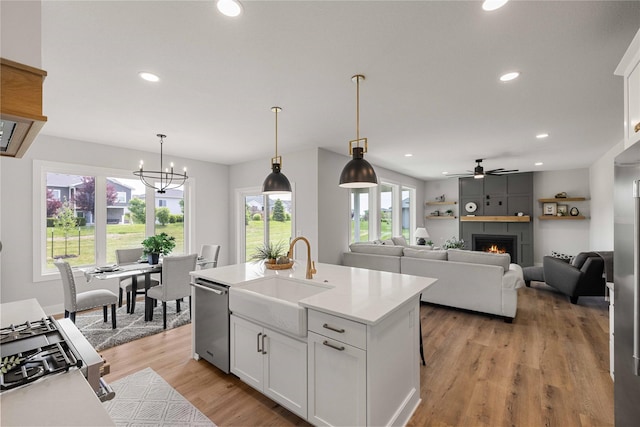 1252 S Radley St, West Des Moines, IA 50266 - kitchen featuring a sink, appliances with stainless steel finishes, white cabinets, recessed lighting, and light countertops