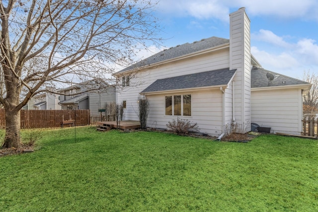 rear view of property featuring a deck and a lawn