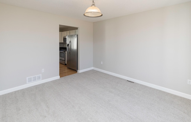 empty room featuring light colored carpet