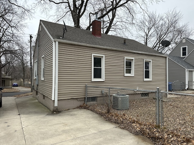 back of house with central AC unit and a patio