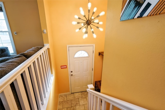 foyer featuring a chandelier