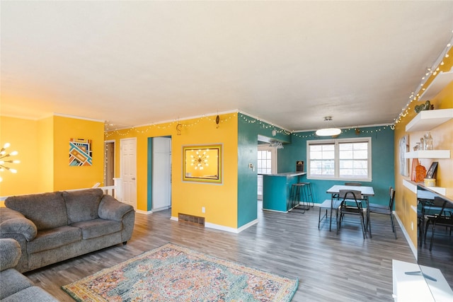 living room with dark wood-type flooring and ornamental molding