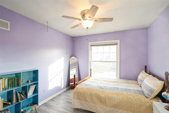 bedroom featuring hardwood / wood-style flooring and ceiling fan