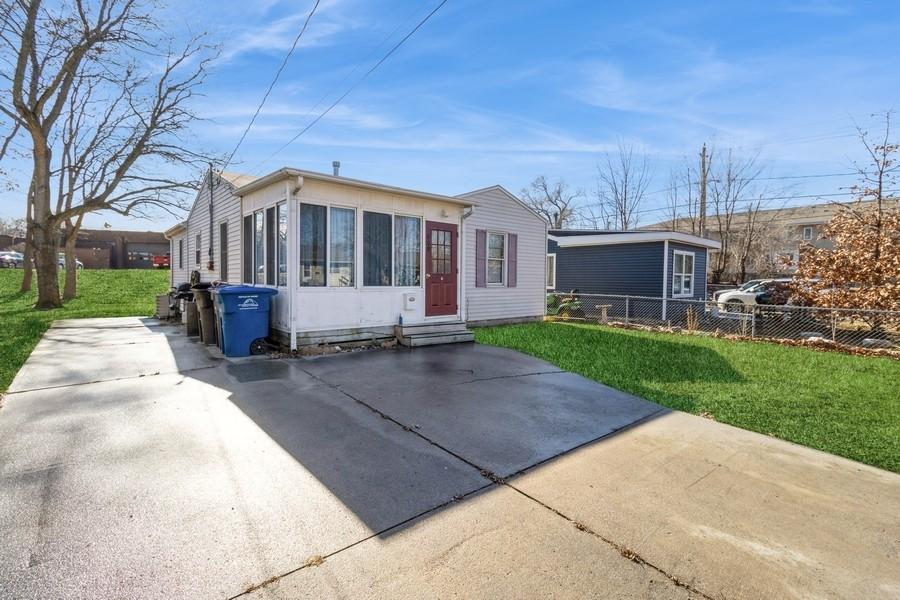 rear view of property featuring a yard