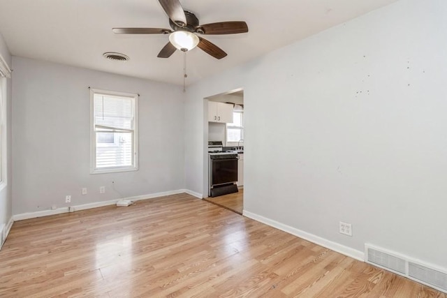 empty room with ceiling fan and light wood-type flooring