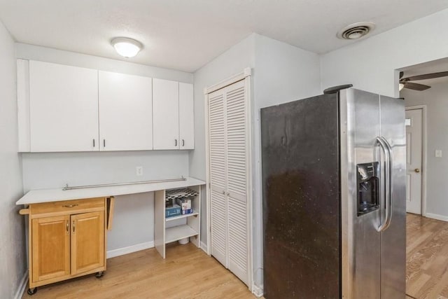 kitchen with white cabinetry, ceiling fan, stainless steel fridge, and light wood-type flooring