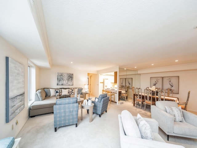 living room with crown molding and light carpet