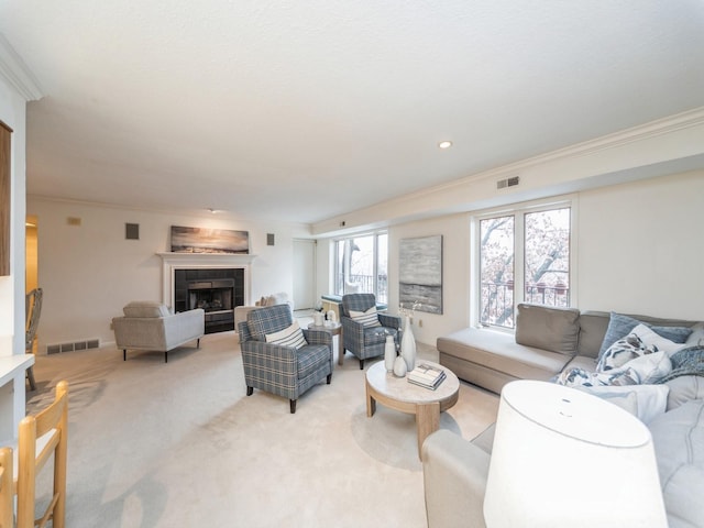 living room featuring light carpet, crown molding, and a fireplace