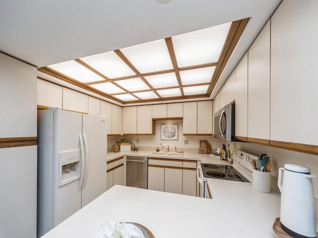 kitchen with appliances with stainless steel finishes, sink, and kitchen peninsula