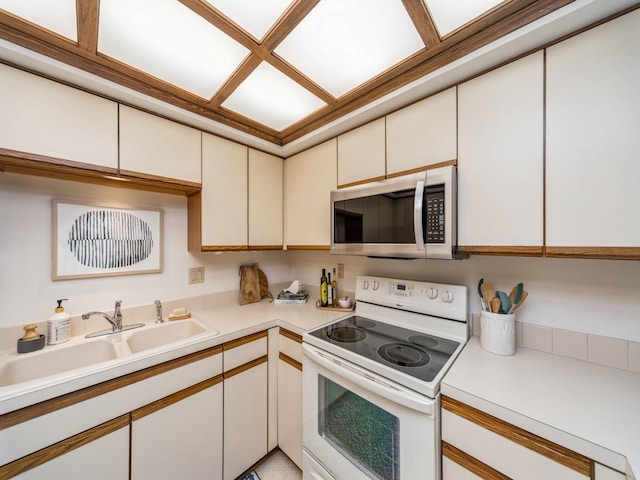 kitchen with sink and white electric range oven