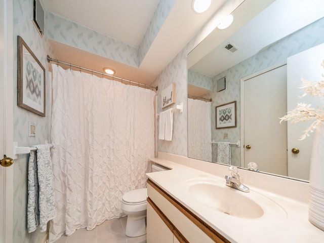 bathroom with vanity, tile patterned floors, and toilet