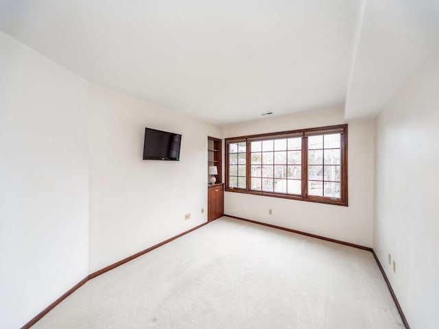 spare room featuring light colored carpet