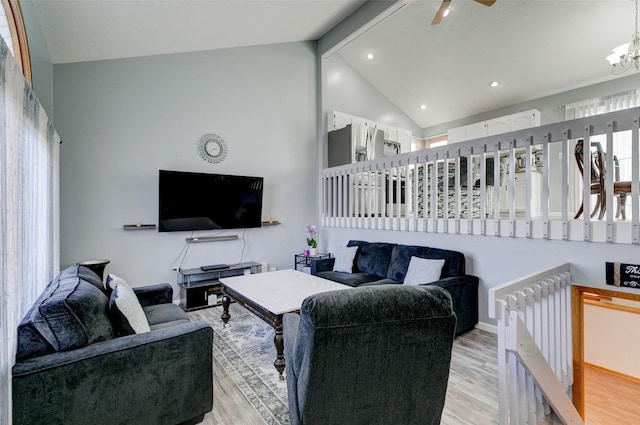 living room with radiator, high vaulted ceiling, a notable chandelier, light hardwood / wood-style floors, and beamed ceiling