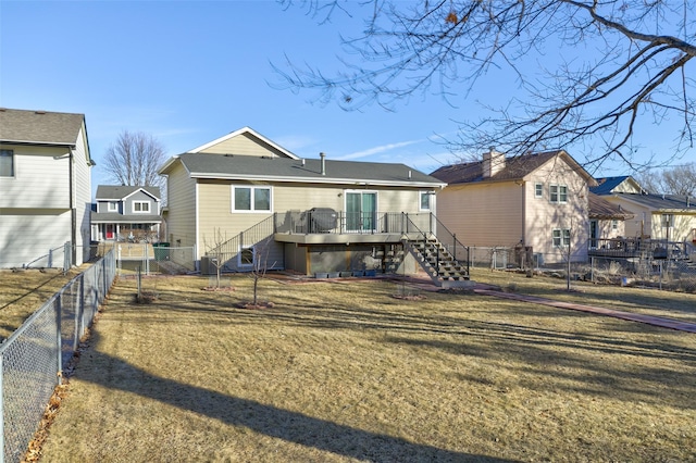 back of property with a wooden deck, a yard, and central AC