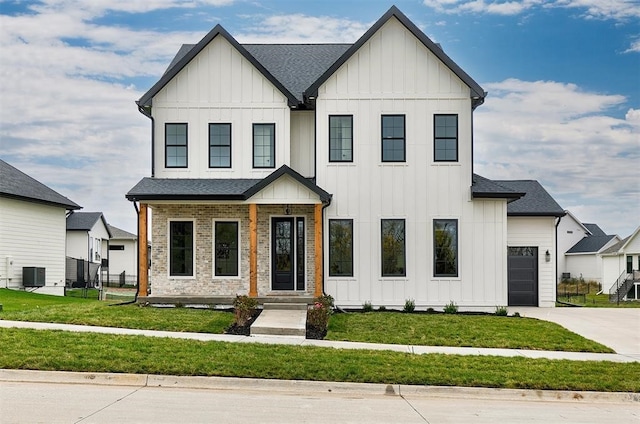 modern inspired farmhouse featuring a garage, cooling unit, and a front lawn