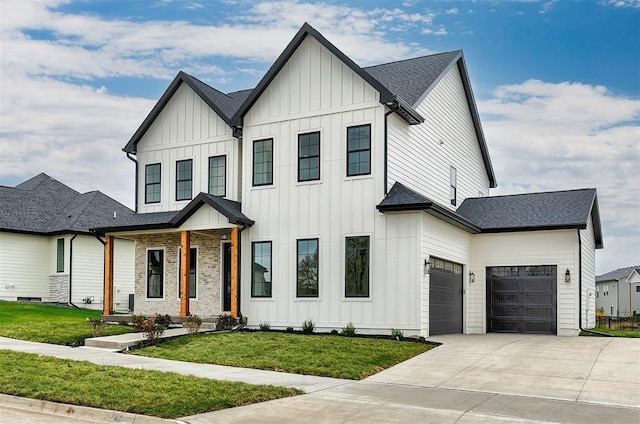 modern farmhouse style home featuring a garage and a front lawn