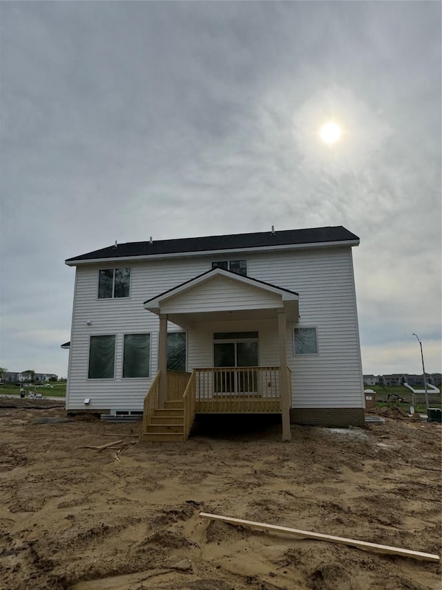 rear view of house with covered porch