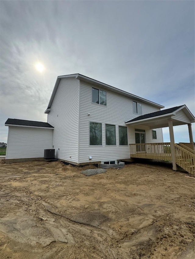 rear view of property with central AC and a wooden deck