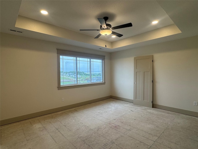 301 S Walnut Dr, Norwalk, IA 50211 - empty room with a tray ceiling, ceiling fan, and recessed lighting
