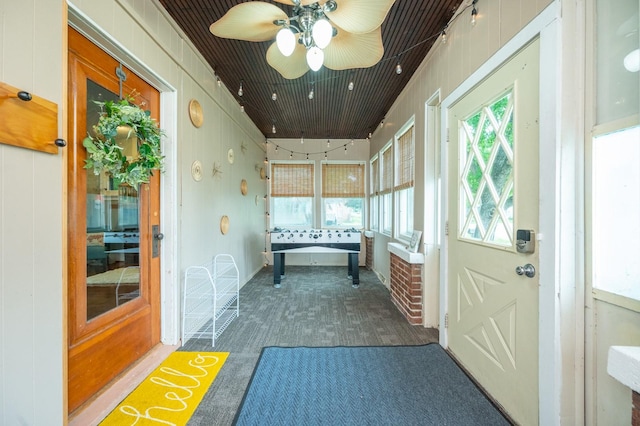 doorway with dark colored carpet