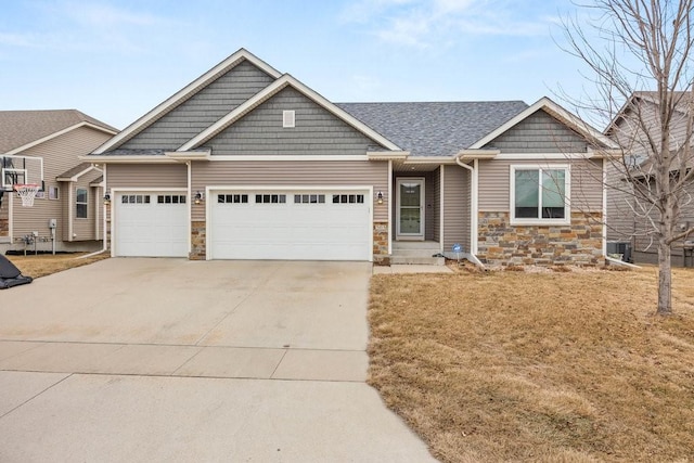 craftsman house featuring cooling unit and a garage