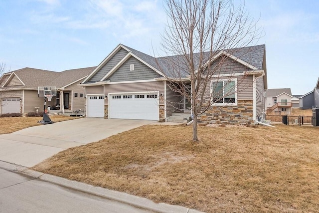 craftsman inspired home with a garage and a front lawn