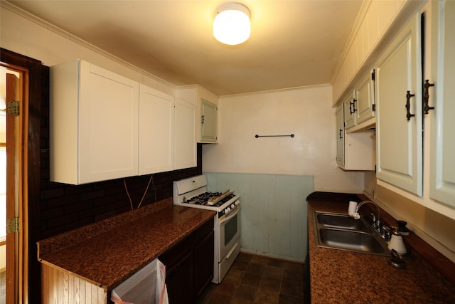 kitchen featuring white cabinetry, sink, and white gas stove