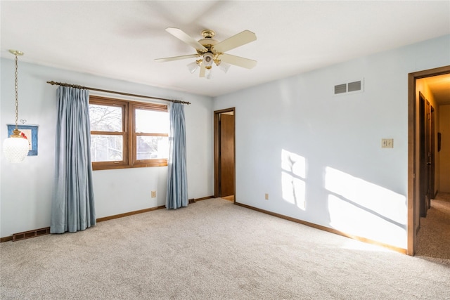 carpeted empty room featuring ceiling fan