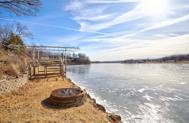 view of water feature with a fire pit