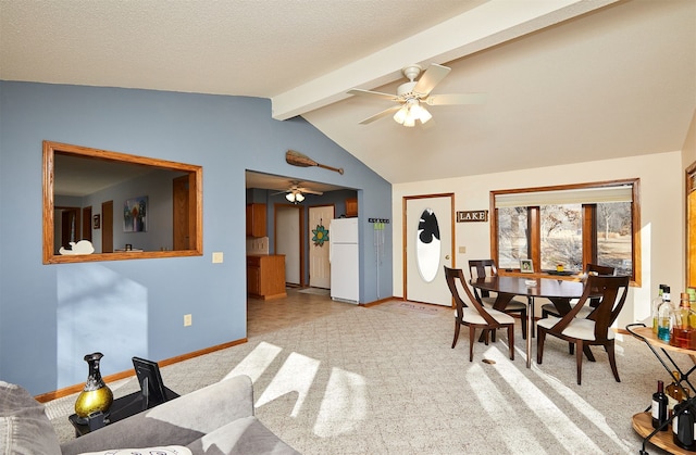 dining area featuring light carpet, vaulted ceiling with beams, a textured ceiling, and ceiling fan